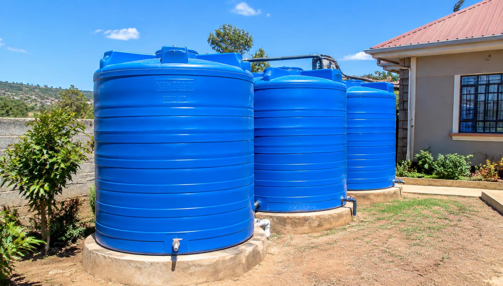 Blue Kentanks water storage tanks installed outside a home in Kenya